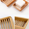A set of natural bamboo soap dishes with wooden slats for fast-drying soap, shown in various angles.