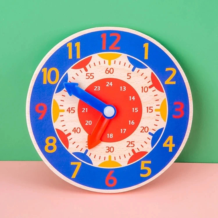 A blue wooden clock face with colorful numbers and hands, set against a green background.