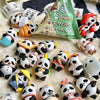 A collection of blind box panda figures in various poses and colors scattered on a light background.