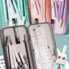 A set of nine compass rulers and drawing tools in various colors stored in pink, teal, and gray cases.