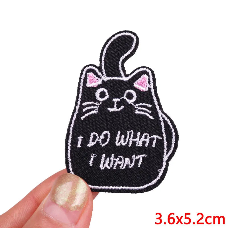Black embroidered iron-on patch of a cat saying I DO WHAT I WANT