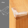 A clear silicone corner edge guard is shown placed on a wooden surface for baby safety.