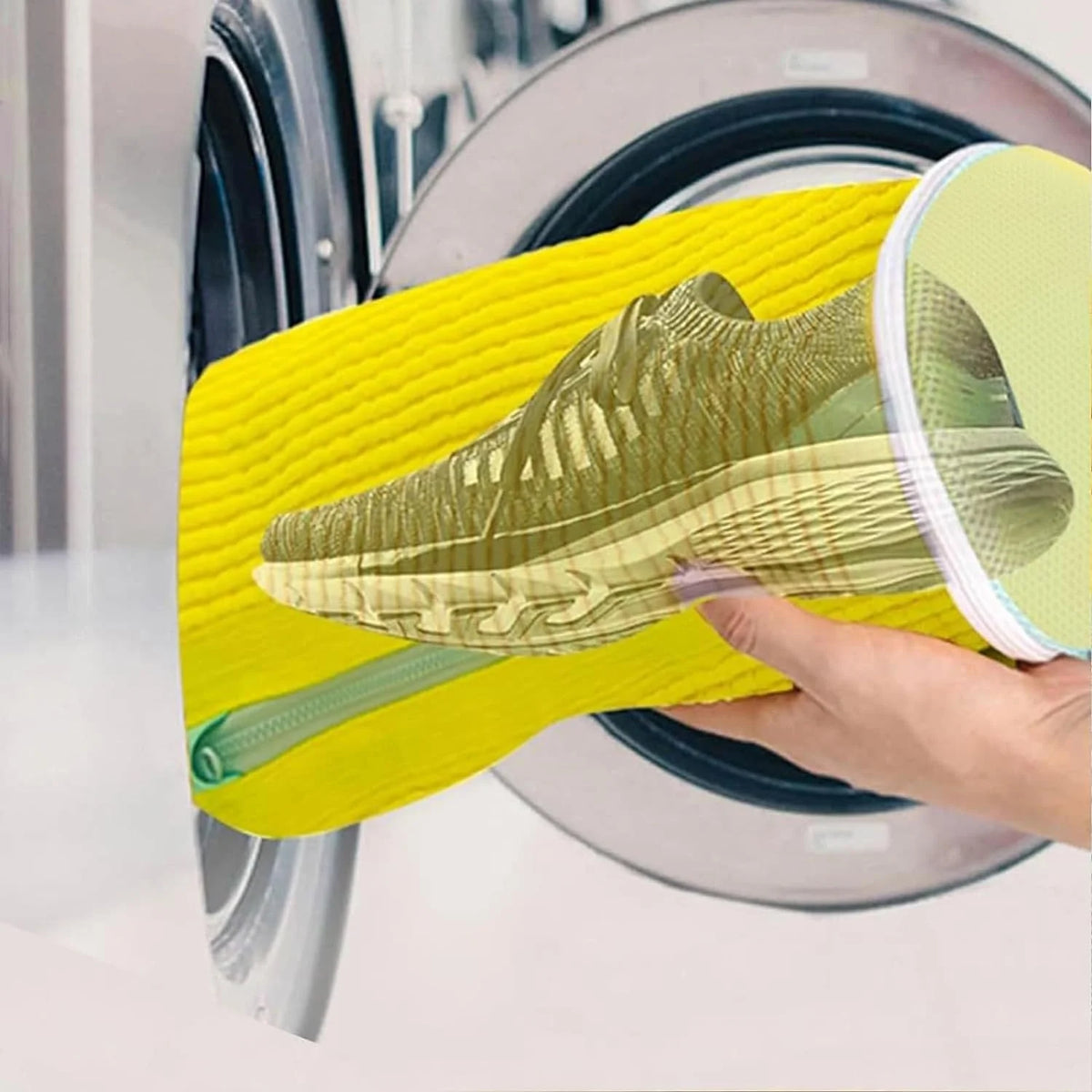 A hand holds a yellow reusable shoe washing bag with soft bristles over a plate, showing the shoe inside.