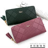 A dark green quilted PU leather wristlet clutch wallet with a gold tassel and a mauve pink version.
