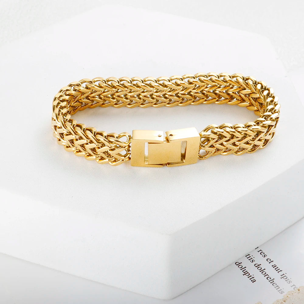 A chunky gold stainless steel link chain bracelet displayed on a white background.