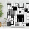 Geometric black and white fabric shower curtain featuring various square and rectangular shapes.
