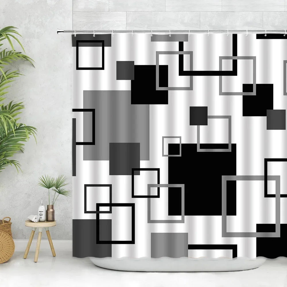 Geometric black and white fabric shower curtain featuring various square and rectangular shapes.