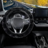 Interior view of a car showing a black fuzzy steering wheel cover and dashboard controls.