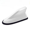 A white aerodynamic shark fin car antenna with a black base and signal amplifier.