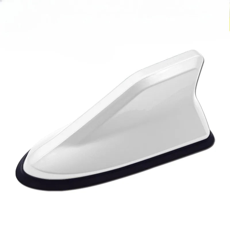 A white aerodynamic shark fin car antenna with a black base and signal amplifier.