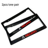 A pair of black racing style license plate frames with a JDM aesthetic.
