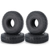 A pair of black rubber mud terrain tires for Monster Truck use, shown in a stack.