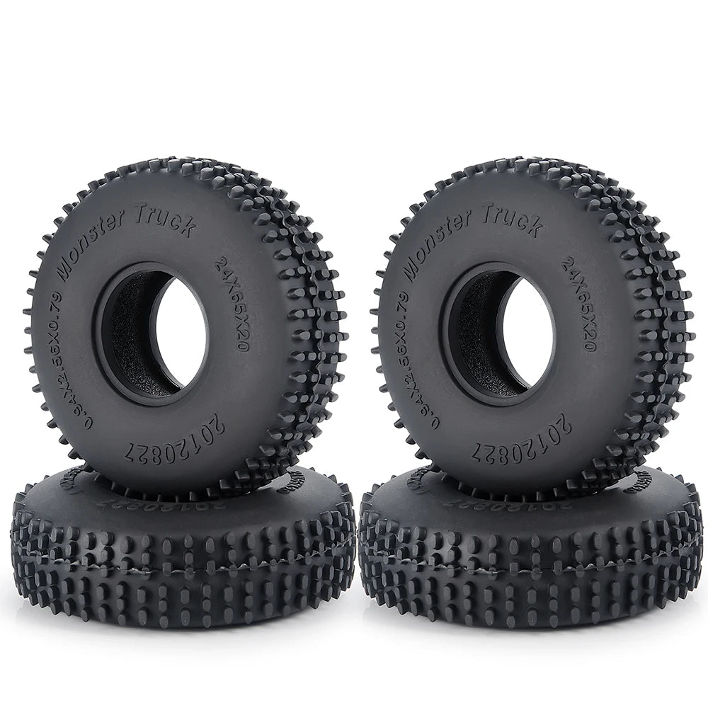 A pair of black rubber mud terrain tires for Monster Truck use, shown in a stack.