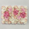 A wall panel composed of pink and white silk rose flowers for weddings and events.