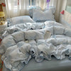 A light blue floral duvet cover set with matching pillowcases and a flat sheet displayed on a bed.