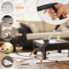A hand is using an extra-long foldable grabber tool with a rotating magnetic jaw to pick up various items like glass, waste, 