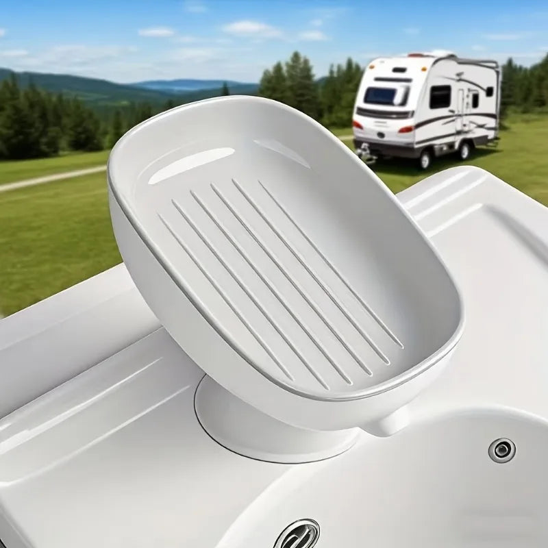 A white bathroom soap rack with a drain tray and suction cup is shown on a white surface.