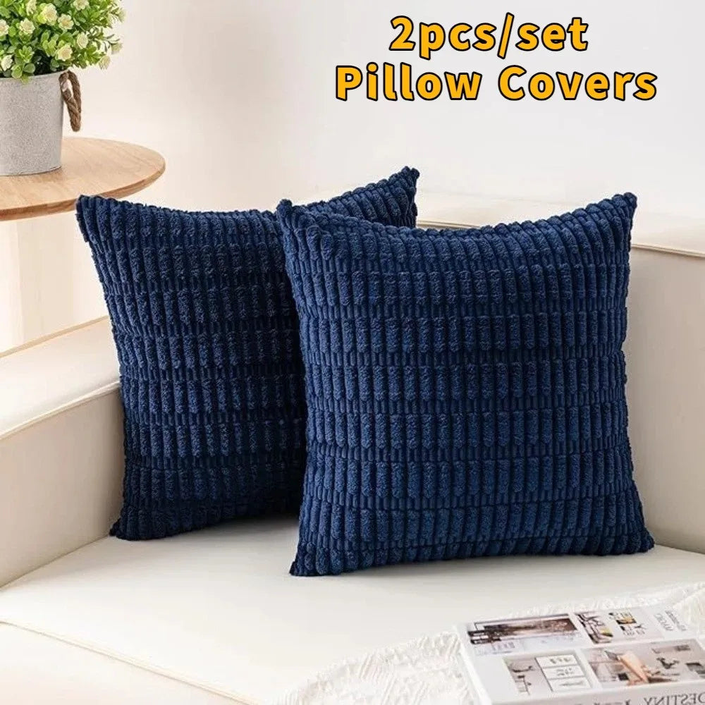 A set of two navy blue corduroy pillow covers with a striped velvet design