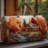 A quilted travel duffle bag featuring a detailed 3D stitching design of an autumn forest landscape and cabin.