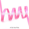 Pink satin ribbon in a wavy shape shown against a white background