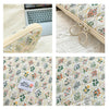 Floral printed fabric laptop sleeve featuring a zipper closure and decorative rings