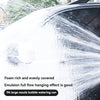 Close-up of a car being washed with foam from a high-pressure foam cannon