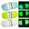 Three spools of glow-in-the-dark polyester yarn for knitting and crochet in light blue, lime green, and white.