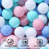 A close-up view of a variety of colorful, smooth ball pit balls in shades of pink, blue, and white.