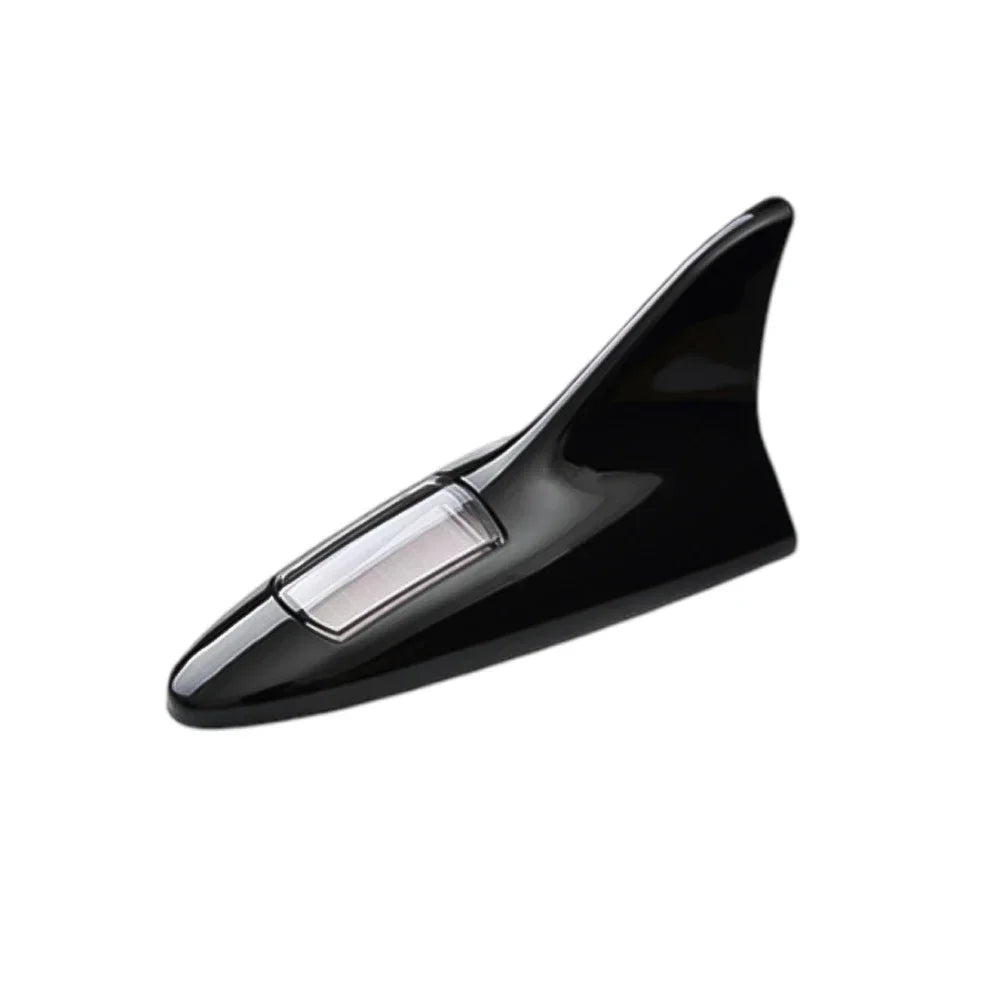 Black solar-powered shark fin antenna with an integrated LED safety light