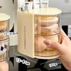 A hand holds a clear acrylic hair accessories organizer with rotating compartments, showing the size of the product.