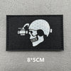 A black embroidered patch featuring a white skull with a scope and a crosshair design.