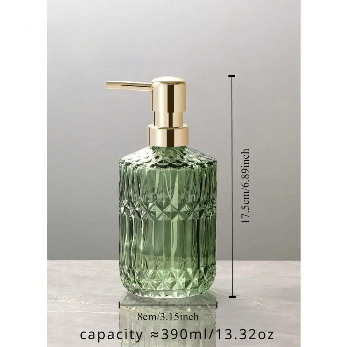 A clear green glass soap dispenser with a gold pump top, shown against a light gray background.