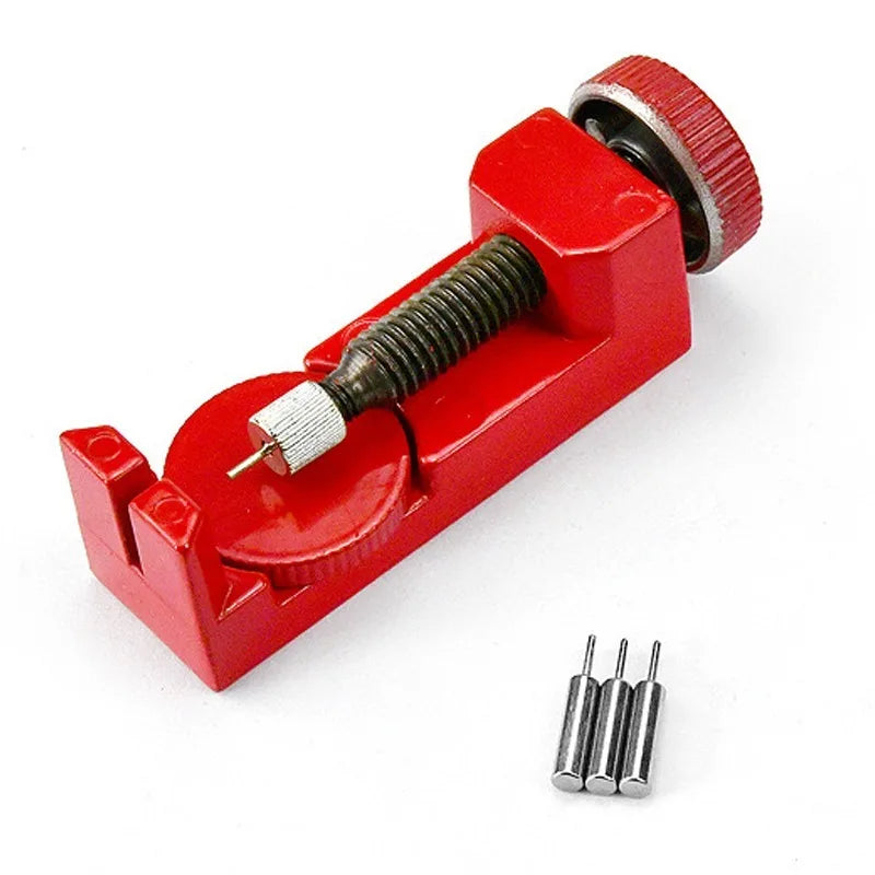 A red watch band link remover and pin extractor kit with a threaded tool and several pins.