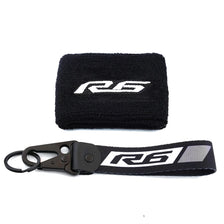 Black neoprene sock with an R6 logo and a black strap for a brake fluid reservoir cover.