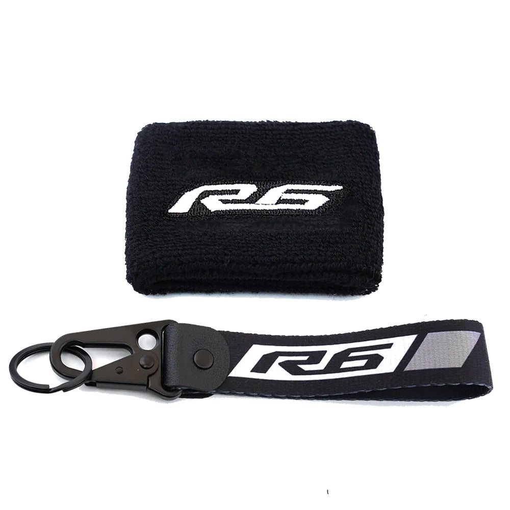 Black neoprene sock with an R6 logo and a black strap for a brake fluid reservoir cover.