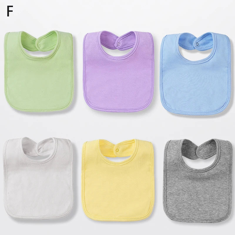 A set of six cotton bandana bibs in pastel colors including green, purple, blue, white, yellow, and gray.