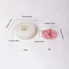 A white silicone mold shaped like a rose bloom for chocolates, candy, and fondant.