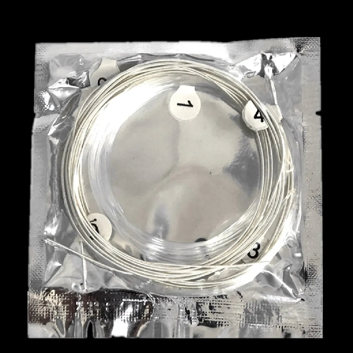 A silver-plated nylon guitar string set is packaged in clear plastic with numbered strings.