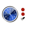 A round blue quartz clock face with luminous hands and a black mounting piece.