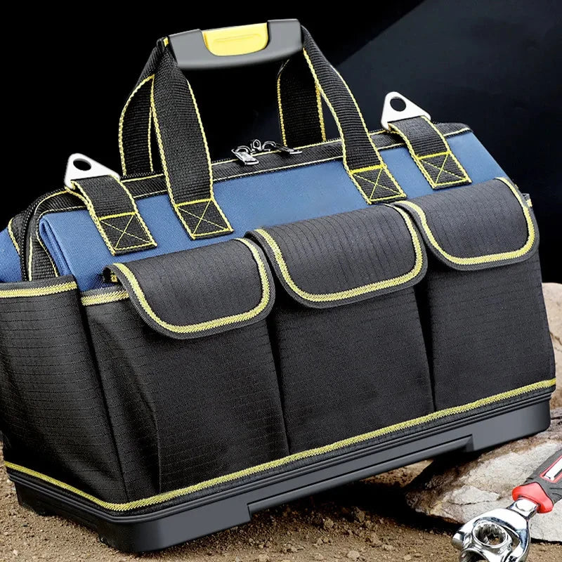 A dark blue and black heavy-duty waterproof tool organizer bag with multiple pockets resting on a rock.