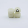 A set of white urethane fingerboard wheels with visible bearings.