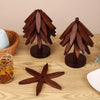 A set of dark brown wooden tree design coasters and folding placemats displayed on a light wood surface.