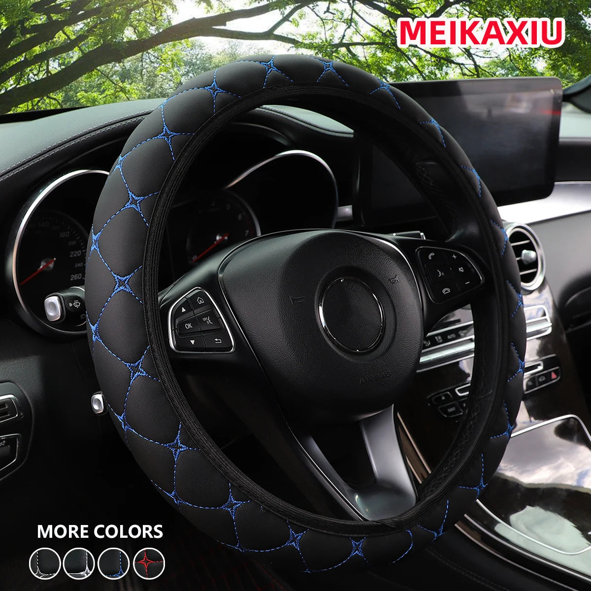 Close-up of an embroidered blue leather steering wheel cover installed in a car interior.