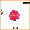 Pink embroidered rose iron-on patch with a yellow center