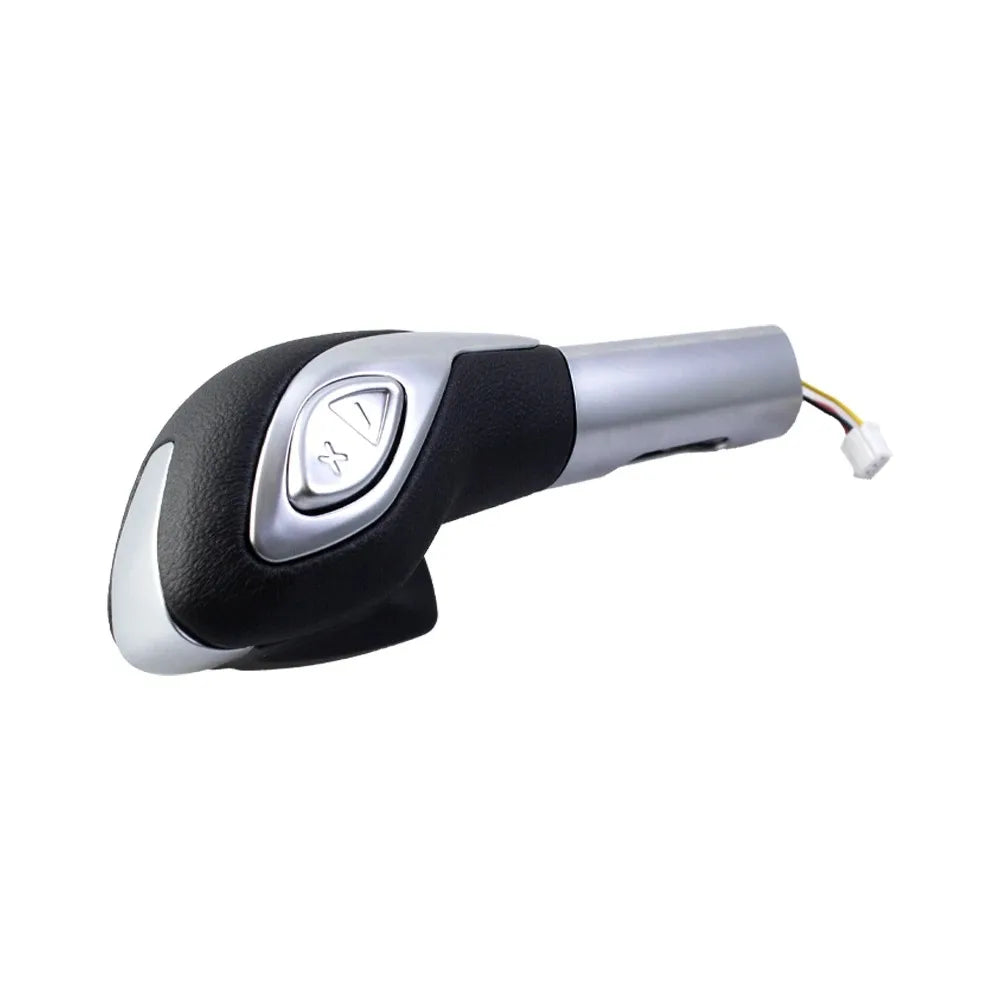 A silver and black leather-wrapped gear shift knob for a Ford vehicle.