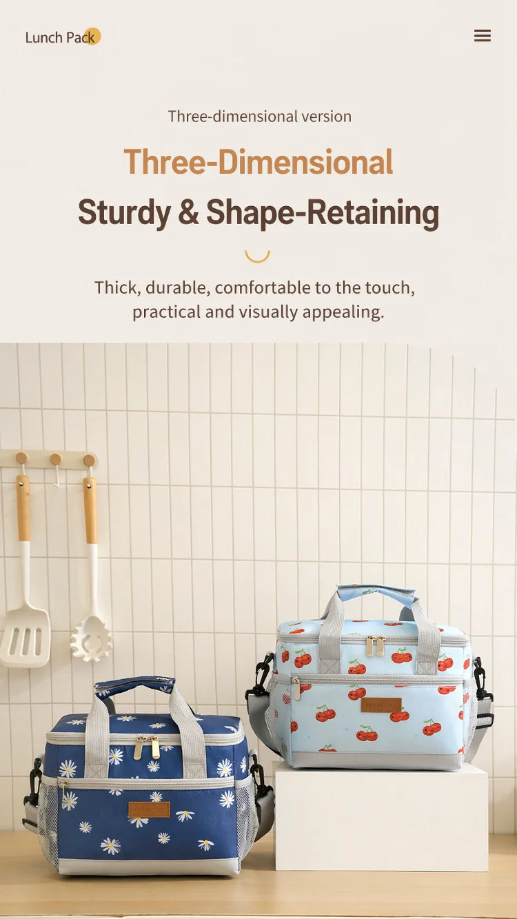 A blue and white insulated lunch bag with a handle is displayed on a white box against a light background.
