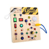 A wooden busy board with various switches, lights, and sensory components for toddlers.