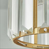 A close-up view of a crystal pendant light with an iron frame and clear glass shade.