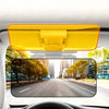 Yellow car sun visor extender with a night shield mounted in a vehicle interior.