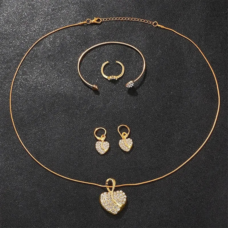 Gold rhinestone watch and jewelry set featuring a necklace and bracelet on a black background
